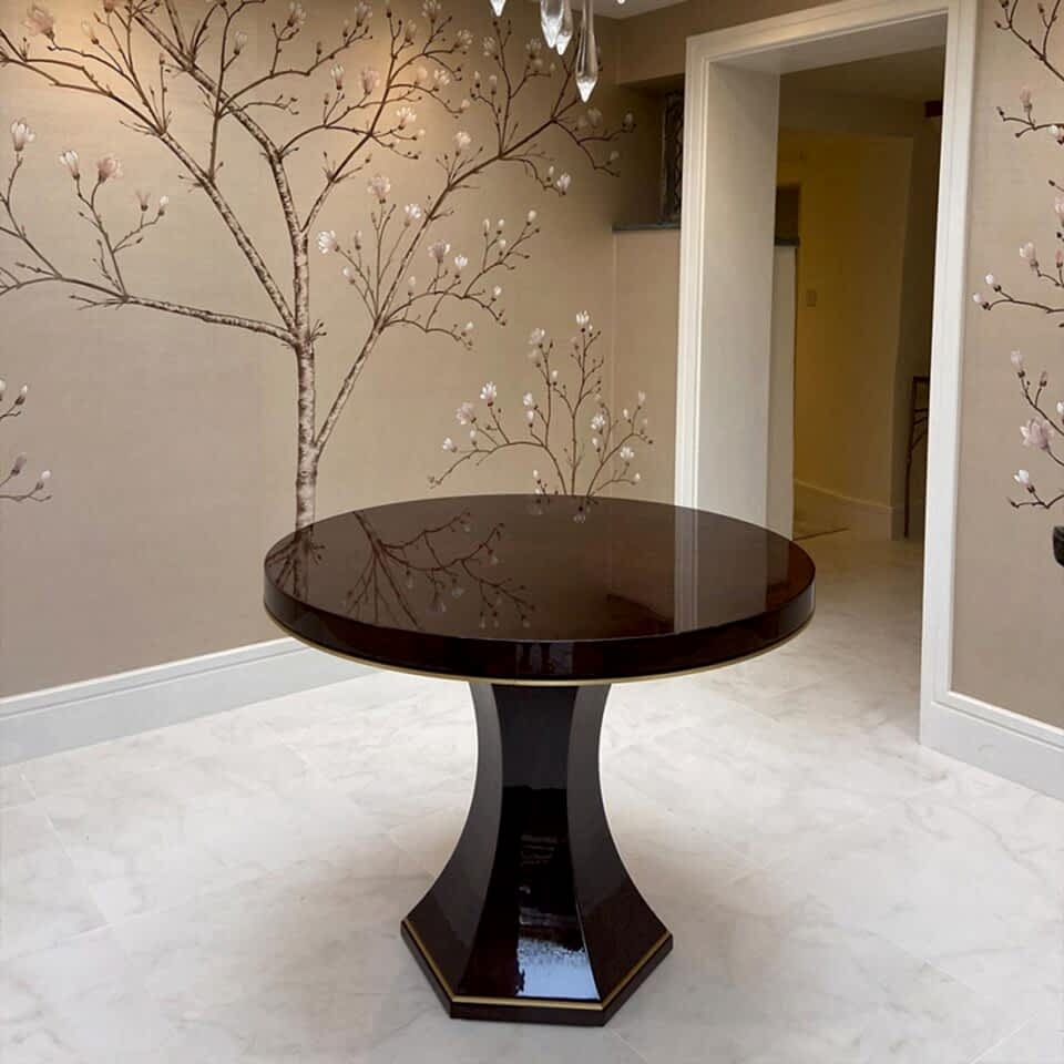 The Chatsworth Dining Table by DAVIDSON London is finished in a high gloss sycamore black with a brushed brass trim. Beautifully styled by Beausala.