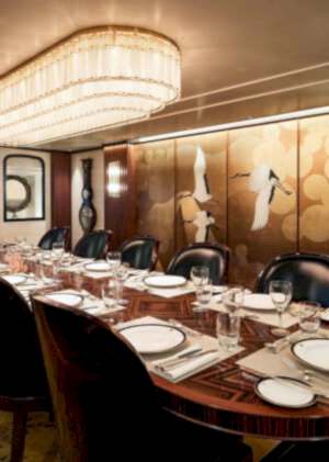 Modern dining room furniture set in a super yacht with a luxury dining set that matches the yacht's interior.