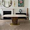 a front on view of the Magdon luxury bronze dining table in a luxury residence